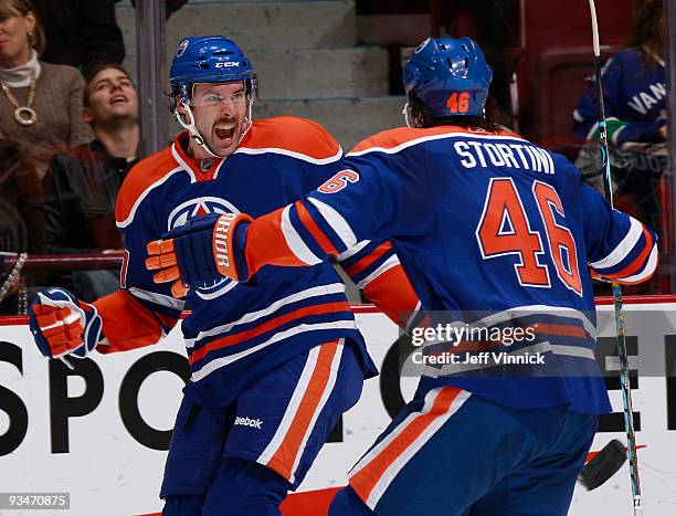 Colin McDonald of the Edmonton Oilers celebrates his first NHL goal with teammate Zack Stortini during their game against the Vancouver Canucks at...