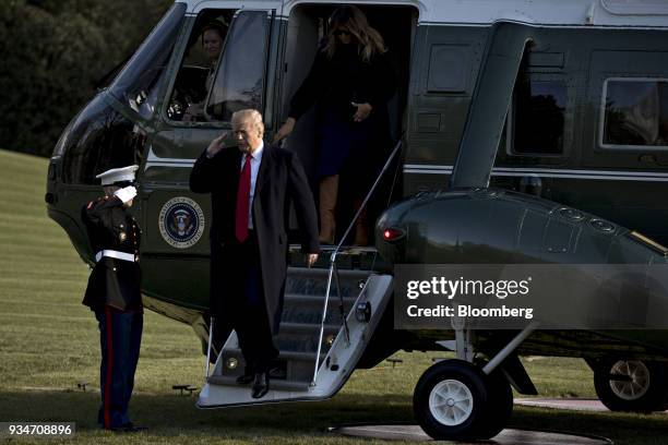 President Donald Trump salutes while walking off Marine One on the South Lawn of the White House in Washington, D.C., U.S., on Monday, March 19,...