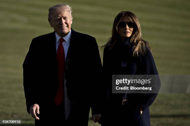 President Donald Trump and First Lady Melania Trump, right, walk on the South Lawn of the White House in Washington, D.C., U.S., on Monday, March 19,...