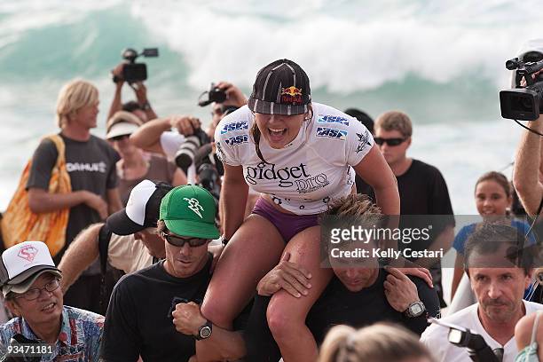Carissa Moore is chaired up the beach by her support team Myles Padaca and Pancho Sullivan, all of Hawaii, after winning the Gidget Pro on November...