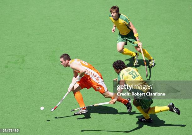 Robert Van Der Horst of the Netherlands is chased by Edward Ockenden and Desmond Abbott of Australia during the match between Australia and the...