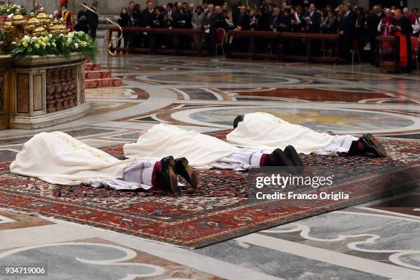 New appointed bishops Waldemar Stanislaw Sommertag, Alfred Xuareb and Jose Bettencourt pray during the episcopal ordinations in St. Peter's Basilica...