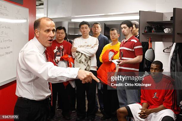 Coaches from the Chinese Basketball Association listen to Head Coach Bob MacKinnon of the Idaho Stampede gives his pre-game talk before the game...