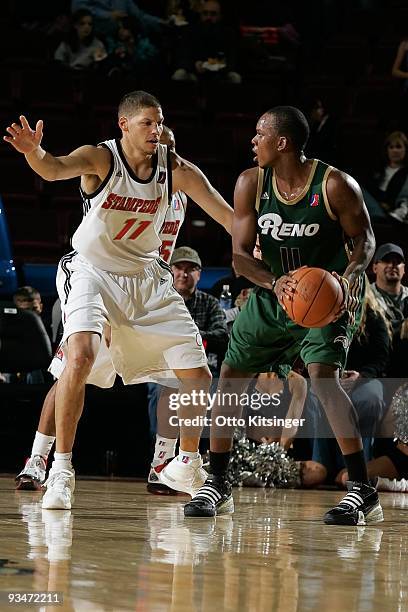 Russell Robinson of the Reno Bighorns looks for a pass around Roberto Bergersen of the Idaho Stampede at Qwest Arena on November 28, 2009 in Boise,...