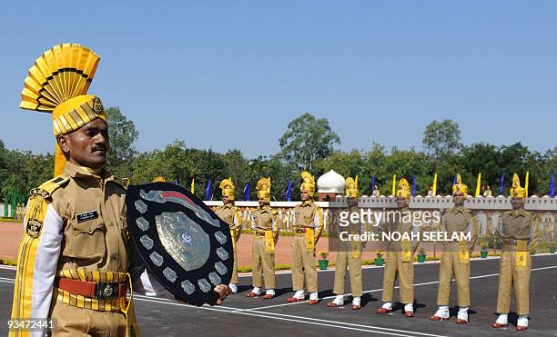 Central Industrial Security Force member P. Karuppa Samy walks with his all round best trophy during the passing out parade of some 335 Sub-Inspector...