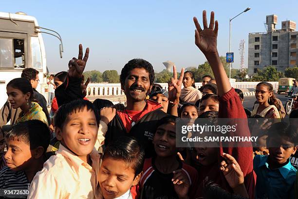 Indian mountaineer Malli Mastan Babu poses with children in Ahmedabad on November 29 following a morale run with some 125 underpriviledged children...