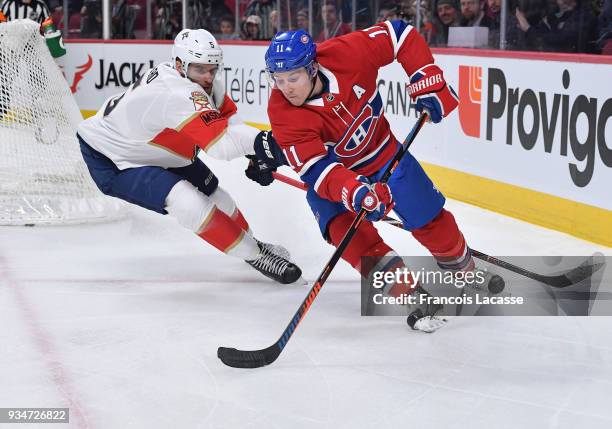 Brendan Gallagher of the Montreal Canadiens skates with the puck under pressure from Aaron Ekblad of the Florida Panthers in the NHL game at the Bell...