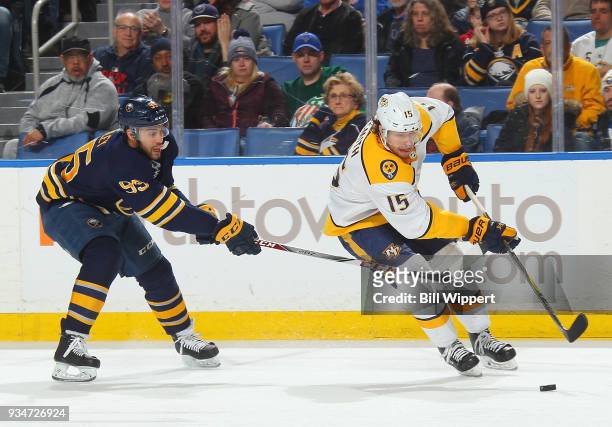 Craig Smith of the Nashville Predators controls the puck against Justin Bailey of the Buffalo Sabres during an NHL game on March 19, 2018 at KeyBank...