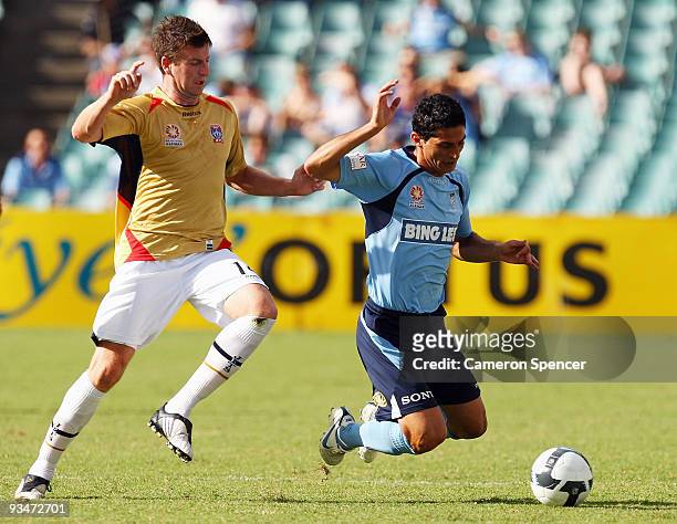 Michael Bridges of the Jets tackles Simon Colosimo of Sydney FC during the round 16 A-League match between Sydney FC and the Newcastle Jets at Sydney...