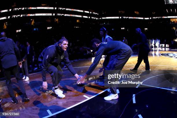 Timofey Mozgov of the Brooklyn Nets high fives his teammate before the game against the Memphis Grizzlies of the Brooklyn Nets on March 19, 2018 at...