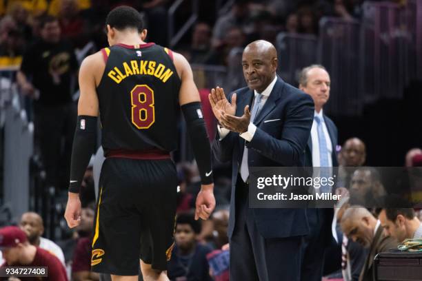 Jordan Clarkson of the Cleveland Cavaliers leaves the game as interim head coach Larry Drew of the Cleveland Cavaliers looks on during the first half...