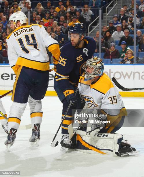 Justin Bailey of the Buffalo Sabres positions himself between Mattias Ekholm and Pekka Rinne of the Nashville Predators during an NHL game on March...