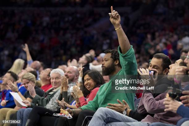 Philadelphia Eagles defensive end Michael Bennett salutes the crowd during a timeout in the game between the Charlotte Hornets and Philadelphia 76ers...