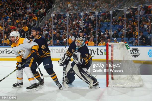 Mike Fisher of the Nashville Predators battles for position against Brendan Guhle and Linus Ullmark of the Buffalo Sabres during an NHL game on March...
