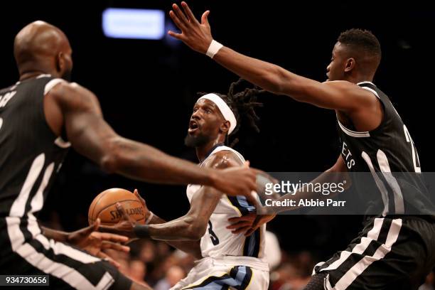 Briante Weber of the Memphis Grizzlies works against Quincy Acy and Caris LeVert of the Brooklyn Nets in the first quarter during their game at...