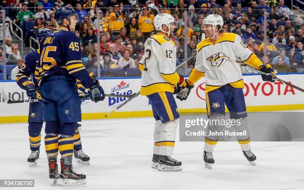 Mike Fisher celebrates his goal with Scott Hartnell of the Nashville Predators against Brendan Guhle of the Buffalo Sabres during an NHL game at...