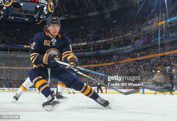Nathan Beaulieu of the Buffalo Sabres reaches for the puck during an NHL game against the Nashville Predators on March 19, 2018 at KeyBank Center in...