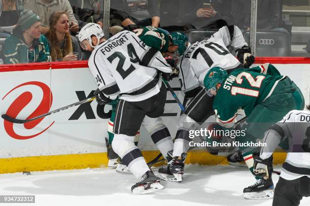 Nick Seeler and Eric Staal of the Minnesota Wild battle for the puck along the boards with Derek Forbort and Tanner Pearson of the Los Angeles Kings...