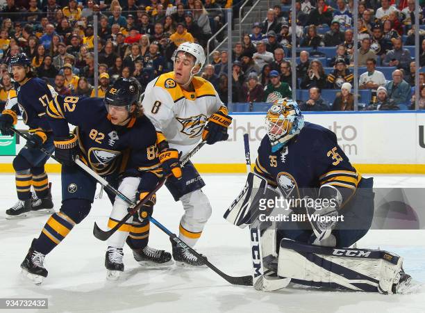 Nathan Beaulieu and Linus Ullmark of the Buffalo Sabres defend the net against Kyle Turris of the Nashville Predators during an NHL game on March 19,...