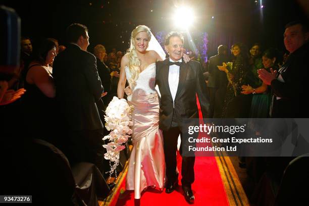 Bride Brynne Gordon and groom Geoffrey Edelsten walk down the aisle after the wedding of Geoffrey Edelsten and Brynne Gordon at Crown Palladium on...