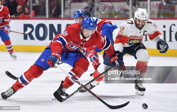 Derek MacKenzie of the Florida Panthers on his 600th NHL game, fights for the puck against Nikita Scherbak of the Montreal Canadiens at the Bell...