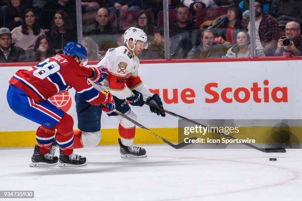 Montreal Canadiens defenseman Mike Reilly tries to reach Florida Panthers defenseman Mike Matheson during the second period of the NHL game between...