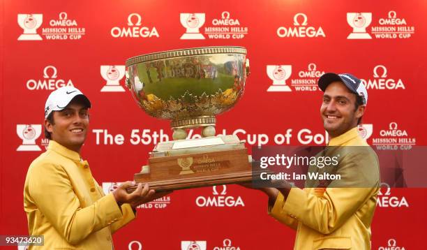 Francesco Molinari and Edoardo Molinari of Italy celebrate with the trophy after winning the Omega Mission Hills World Cup on the Olazabal course on...