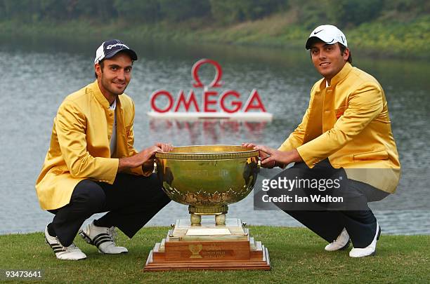 Francesco Molinari and Edoardo Molinari of Italy celebrate with the trophy after winning the Omega Mission Hills World Cup on the Olazabal course on...
