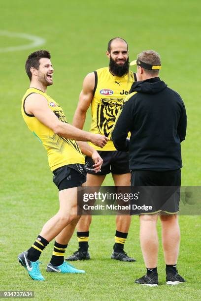 Trent Cotchin of the Tigers and Bachar Houli react to Tigers head coach Damien Hardwick sprints during a Richmond Tigers AFL training session at Punt...