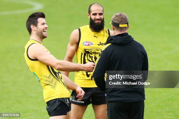 Trent Cotchin of the Tigers and Bachar Houli react to Tigers head coach Damien Hardwick sprints during a Richmond Tigers AFL training session at Punt...