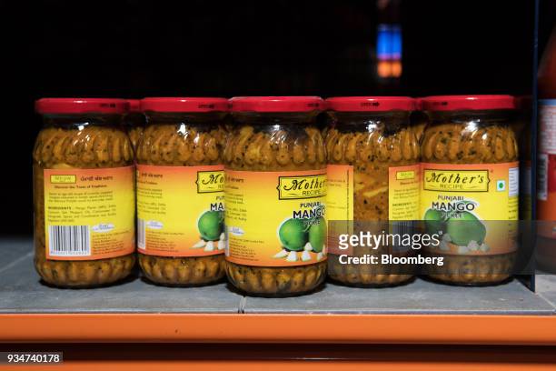 Jars of Desai Brother Ltd.'s Mothers Recipe Punjabi Mango Pickle sit on a shelf at a warehouse of Bigbasket, an e-grocer operated by Supermarket...
