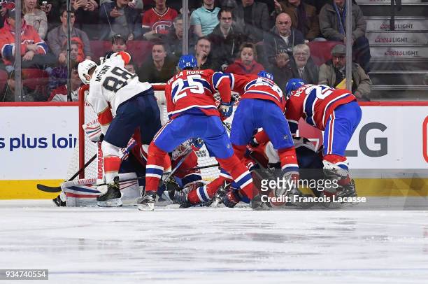 Jacob De La Rose and Noah Juulsen of the Montreal Canadiens defend the net against Jamie McGinn of the Florida Panthers in the NHL game at the Bell...