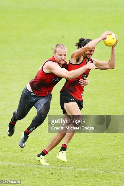 Jake Long is tackled by Jake Stringer during an Essendon Bombers AFL training session at The Hangar on March 20, 2018 in Melbourne, Australia.
