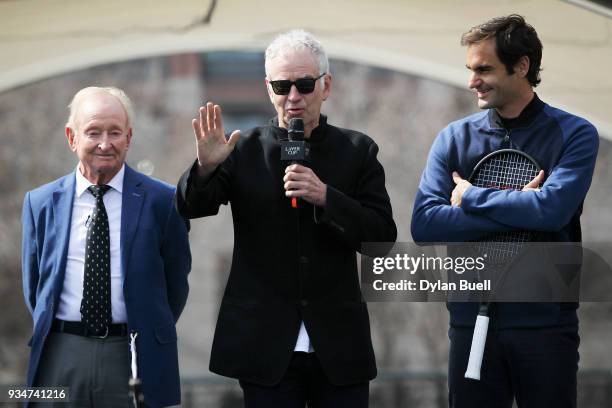 John McEnroe speaks to the crowd as Rod Laver and Roger Federer of Switzerland look on during the Laver Cup 2018 Chicago Launch at Cloud Gate on...