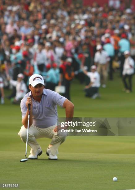 Graeme McDowell of Ireland lines up a put on the 18th green during the Foursome's on the second day of the Omega Mission Hills World Cup on the...