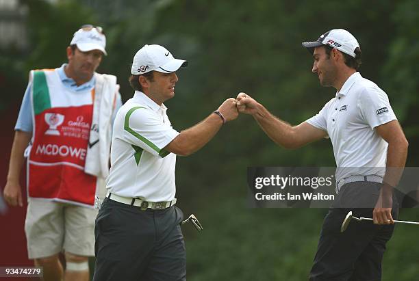 Francesco Molinari and Edoardo Molinari of Italy celebrate during the Foursome's on the second day of the Omega Mission Hills World Cup on the...