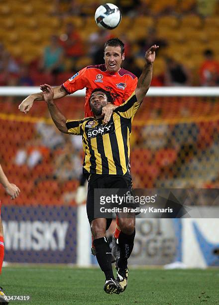 Josh McCloughan of the Roar gets above Paul Ifill of the Phoenix during the round 16 A-League match between the Queensland Roar and the Wellington...