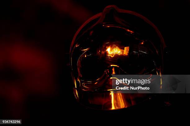 Falla burns reflected on a fireman's helmet during the last day of the Las Fallas Festival on March 19, 2018 in Valencia, Spain. The Fallas is...