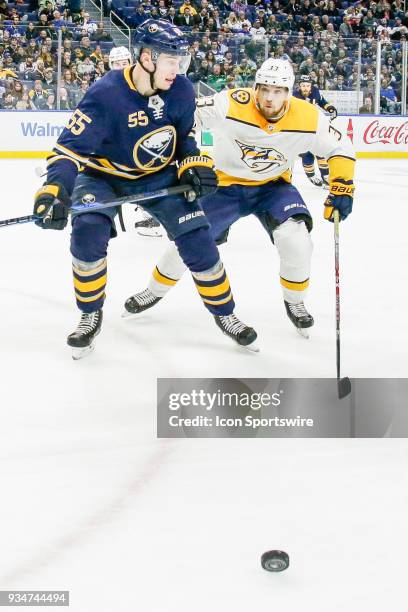 Buffalo Sabres Defenseman Rasmus Ristolainen and Nashville Predators Right Wing Viktor Arvidsson track puck into corner during the Nashville...