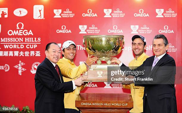 Francesco Molinari, Edoardo Molinari of Italy are presented with the trophy by Doctor David Chu, Chairman of the Mission Hills Group and Stephen...