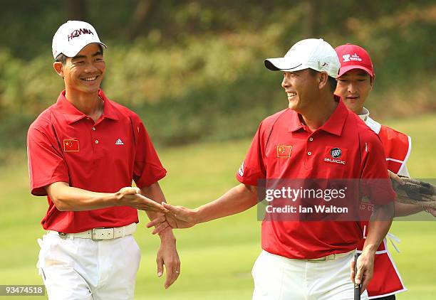 Zhang Lian-Wei and Liang Wen - Chong of China during the Foursome's on the second day of the Omega Mission Hills World Cup on the Olazabal course on...