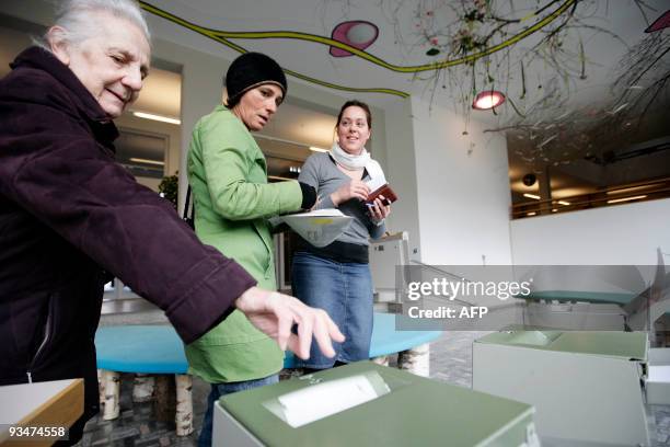 Swiss citizens cast their ballots at the town hall in Uster, near Zurich on November 29, 2009. Switzerland votes on November 29, 2009 on a...