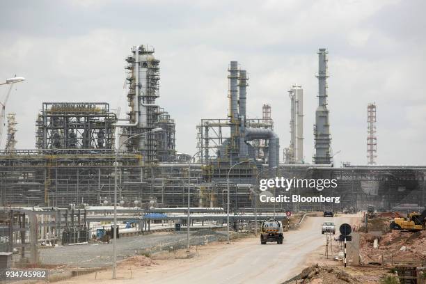 Vehicles drive along a road at the the under construction Petronas Nasional Berhad Refinery and Petrochemical Integrated Development Project, part of...