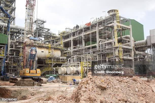 Crane operates at a steam cracker unit at the under construction Petronas Nasional Berhad Refinery and Petrochemical Integrated Development Project,...