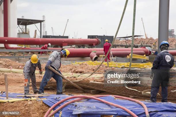 Workers arrange reinforcing steel at the under construction Petronas Nasional Berhad Refinery and Petrochemical Integrated Development Project, part...