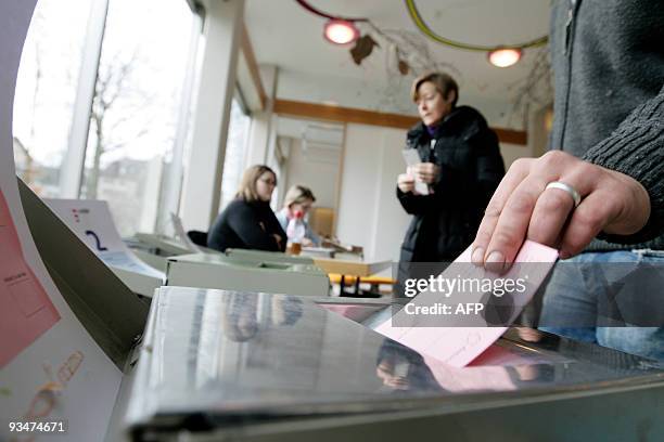 Man casts his ballot at the town hall in Uster, near Zurich on November 29, 2009. Switzerland votes on November 29, 2009 on a controversial call by...