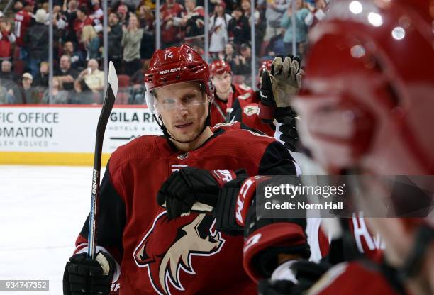 Richard Panik of the Arizona Coyotes is congratulated by teammates after scoring a goal against the Calgary Flames during the second period at Gila...