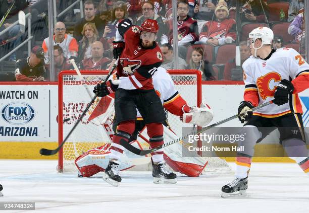 Brendan Perlini of the Arizona Coyotes attempts to re-direct the puck past goalie Mike Smith of the Calgary Flames during the second period at Gila...