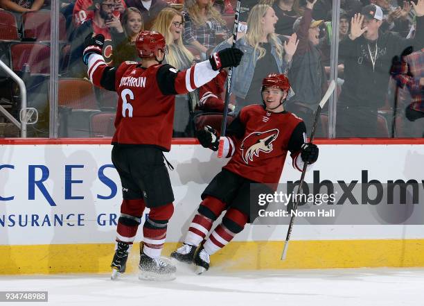 Max Domi of the Arizona Coyotes celebrates with teammate Jakob Chychrun after scoring a goal against the Calgary Flames during the second period at...