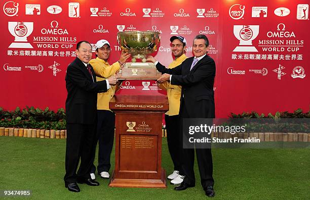 Francesco Molinari, Edoardo Molinari of Italy are presented with the trophy by Doctor David Chu, Chairman of the Mission Hills Group and Stephen...